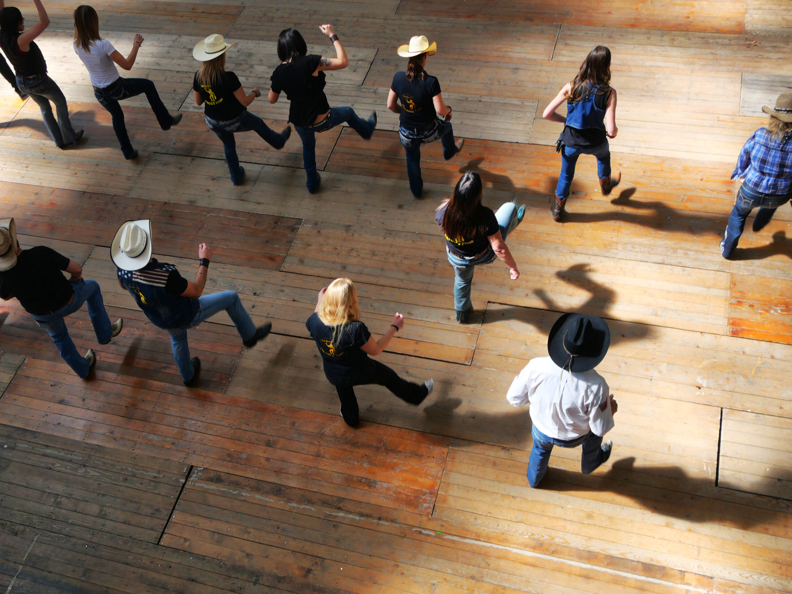 Line dancers wearing cowboy hats at a Country Friday social, Beach Ballroom Toronto
