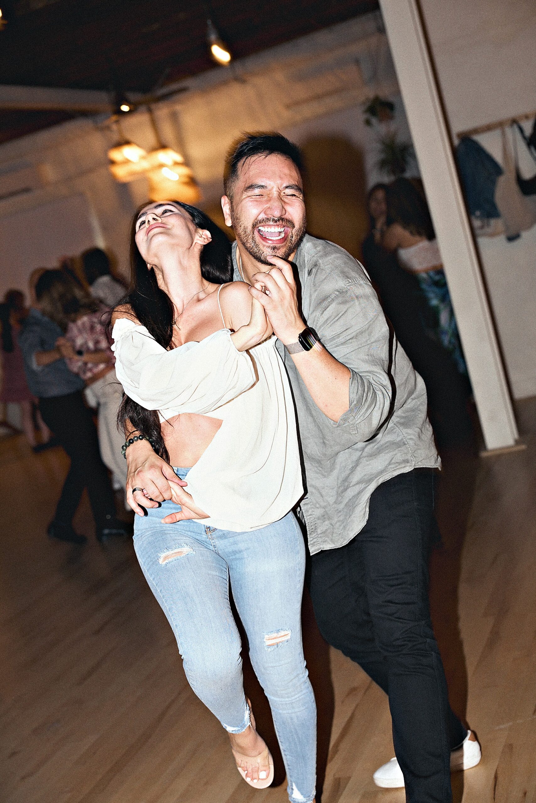 Couple laughing together while dancing at a Beach Ballroom evening social in Toronto