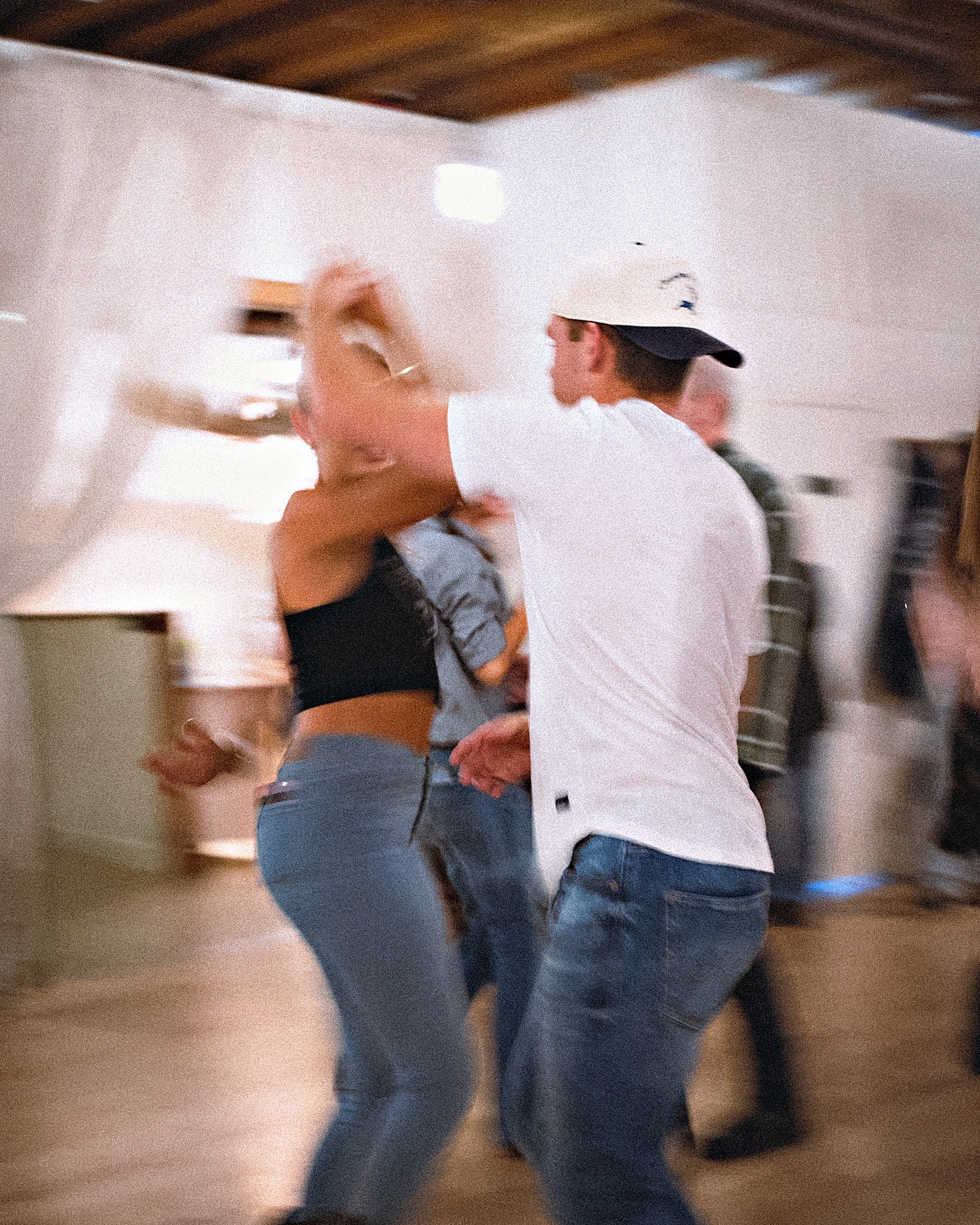 Dancers performing a swing dance move at a Beach Ballroom social in Toronto