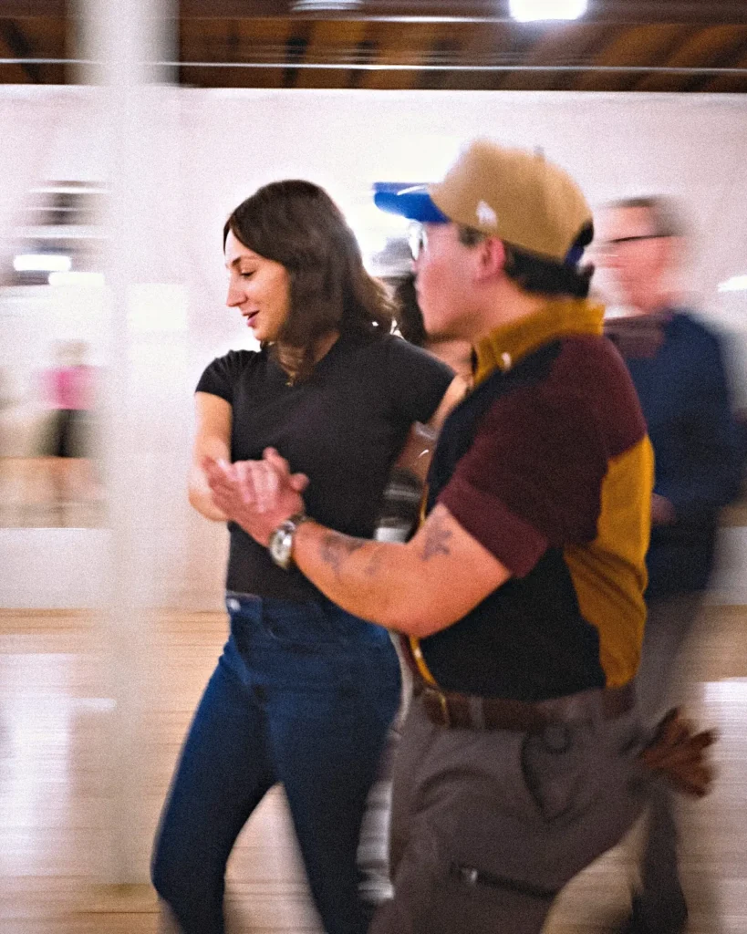 Dancers laughing together on the floor at a Beach Ballroom social night in Toronto