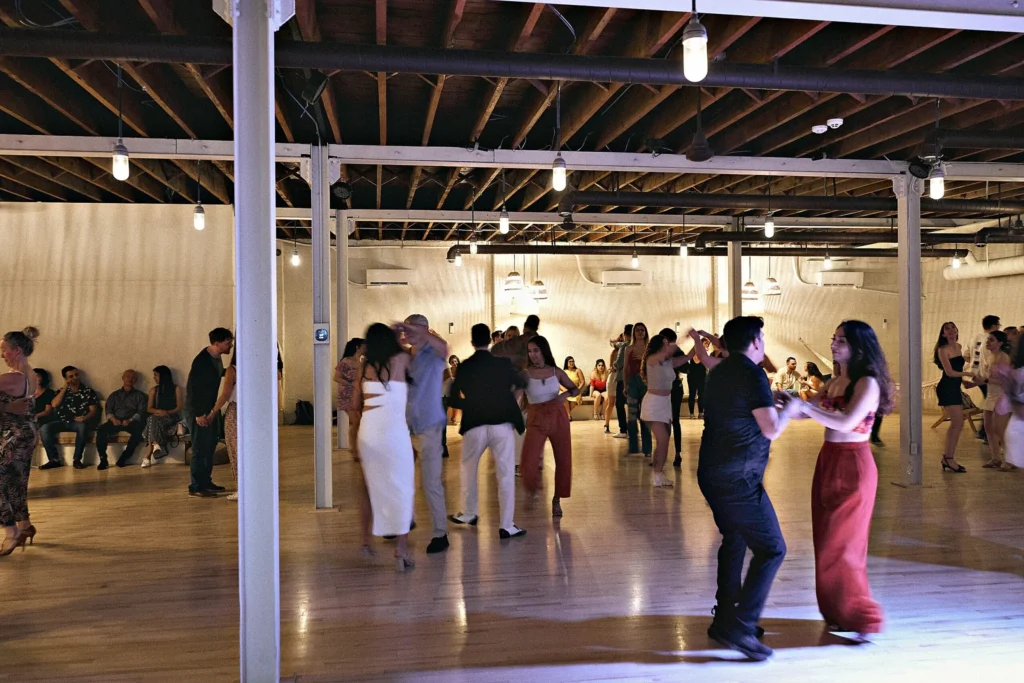 Couples social dancing across the floor at a Beach Ballroom evening social in Toronto
