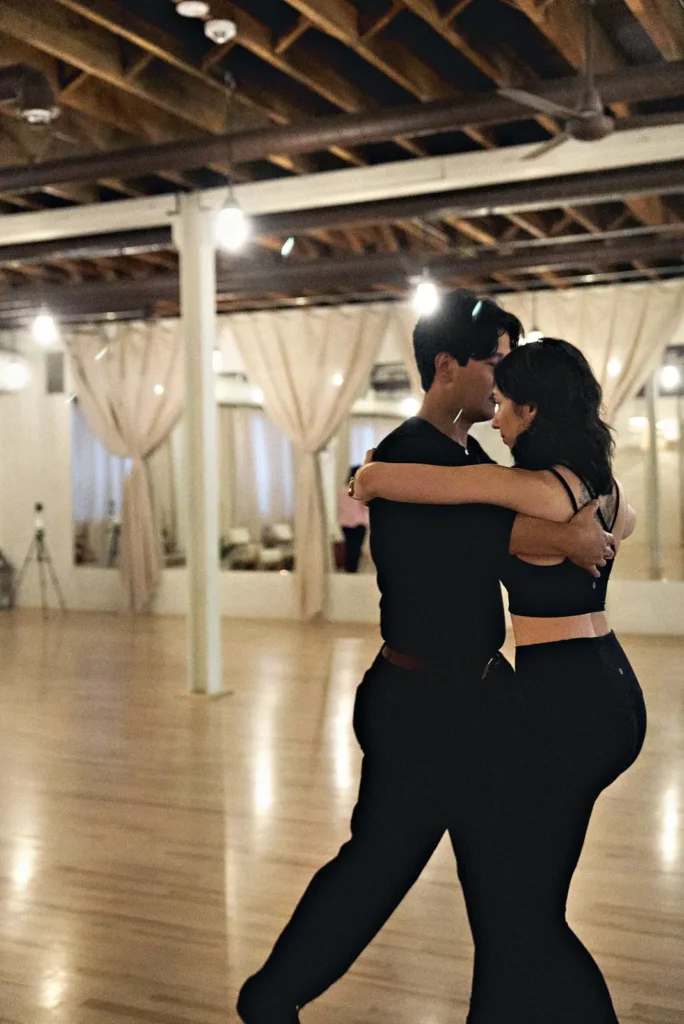 Couple in close hold dancing Latin at a social night at Beach Ballroom in Toronto