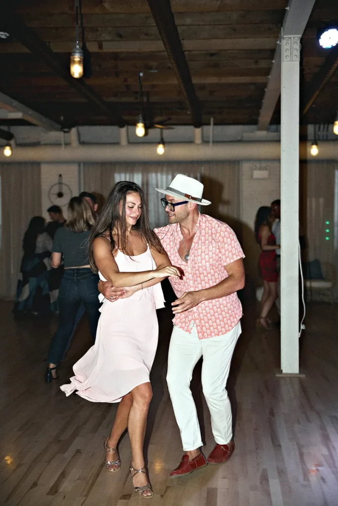 Couple spinning while partner dancing at a Latin social at Beach Ballroom, Toronto