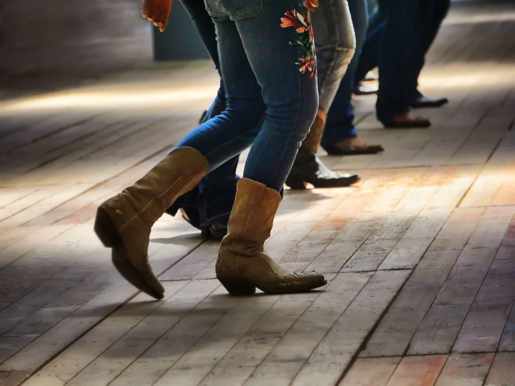 Cowboy boots on a wooden floor during line dancing